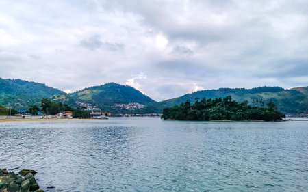 Panorama of tropical islands island nature coast beach with turquoise green and clear water rocks boulders and blue sky in Angra dos Reis State of Rio de Janeiro Brazil.の写真素材