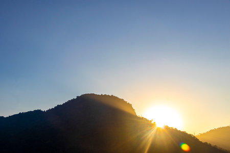 Beautiful golden colorful sunrise sunset behind the tropical mountain hills in Angra dos Reis State...