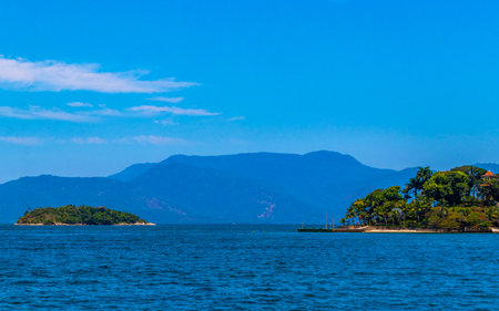 Panorama of tropical islands nature coast beach with turquoise green and clear water rocks boulders and blue sky in Angra dos Reis State of Rio de Janeiro Brazil.の写真素材