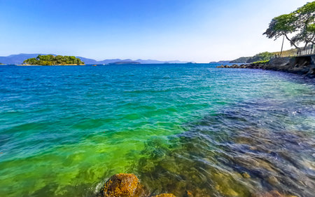 Panorama of tropical islands island nature coast beach with turquoise green and clear water rocks boulders and blue sky in Angra dos Reis State of Rio de Janeiro Brazil.の写真素材