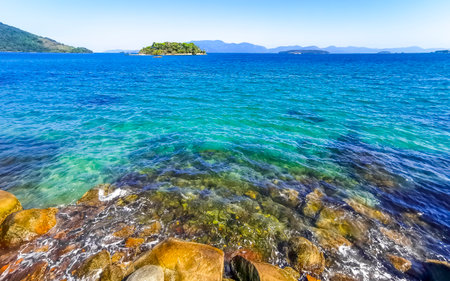 Panorama of tropical islands nature coast beach with turquoise green and clear water rocks boulders and blue sky in Angra dos Reis State of Rio de Janeiro Brazil.の写真素材