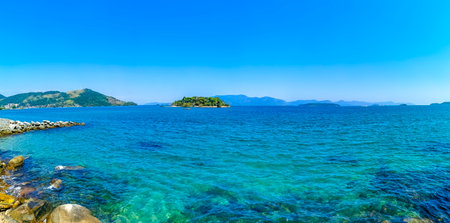 Panorama of tropical islands island nature coast beach with turquoise green and clear water rocks boulders and blue sky in Angra dos Reis State of Rio de Janeiro Brazil.の写真素材