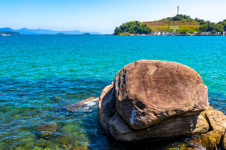 Panorama of tropical islands nature coast beach with turquoise green and clear water rock rocks boulders boulder and blue sky in Angra dos Reis, State of Rio de Janeiro, Brazil.の写真素材
