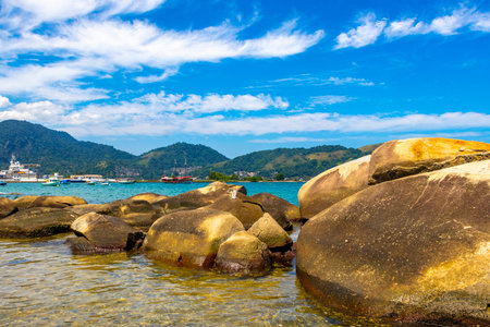 Panorama of tropical islands island nature coast beach with turquoise green and clear water rock rocks boulders boulder and blue sky in Angra dos Reis State of Rio de Janeiro Brazil.の写真素材