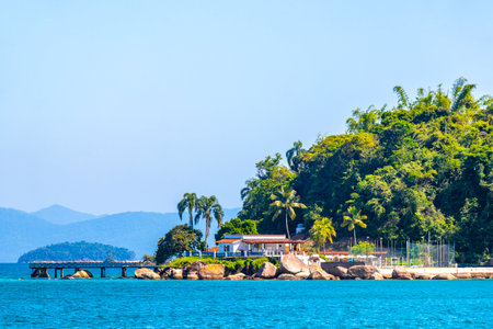 Angra dos Reis State of Rio de Janeiro Brazil October 28, 2020 Panorama of tropical islands island coast beach seascape with turquoise green blue water mountains and pier port with boats.の写真素材