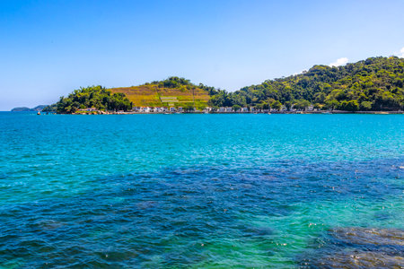 Panorama of tropical islands island nature coast beach with turquoise green and clear water rocks boulders and blue sky in Angra dos Reis State of Rio de Janeiro Brazil.の写真素材