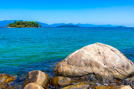 Panorama of tropical island nature coast beach with turquoise green and clear water rock rocks boulders boulder and blue sky.の写真素材