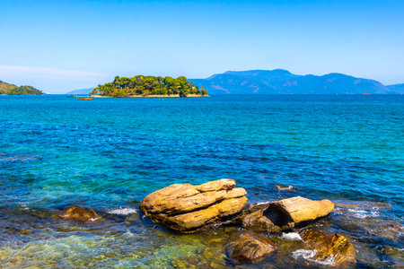 Panorama of tropical islands nature coast beach with turquoise green and clear water rock rocks boulders boulder and blue sky in Angra dos Reis State of Rio de Janeiro.の写真素材