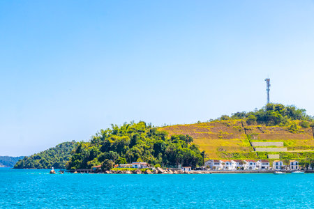 Angra dos Reis State of Rio de Janeiro Brazil October 28, 2020 Panorama of tropical islands island coast beach seascape with turquoise green blue water mountains and pier port with boats in Brazil.の写真素材