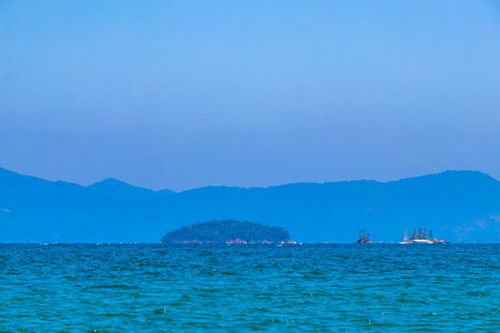 Panorama of tropical islands nature coast beach with turquoise green and clear water rocks boulders and blue sky.の写真素材