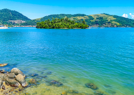 Panorama of tropical islands island nature coast beach with turquoise green and clear water rocks boulders and blue sky in Angra dos Reis State of Rio de Janeiro Brazil.の写真素材