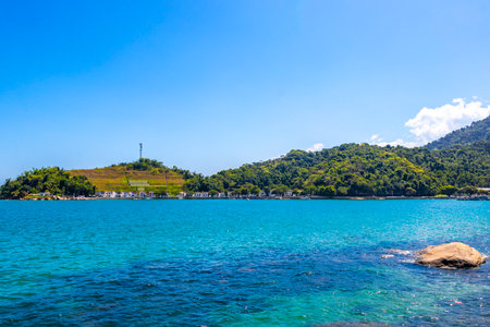 Panorama of tropical islands nature coast beach with turquoise green and clear water rocks boulders and blue sky in Angra dos Reis.の写真素材
