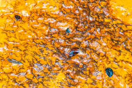 Red river flowing water and waves and waterfall Cachoeira Sucuriju yellow orange brown colors iron...