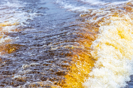Meeting of waters blackwater of Rio Negro and whitewater of Amazon River boat trip tour with tropical jungle rainforest and blue cloudy sky in Iranduba Manaus State of Amazonas Brazil.の写真素材