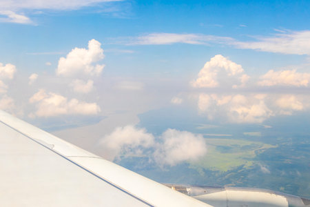 Flight in plane with aerial panorama view out of the window to Amazon river Rio negro tropical jungle rainforest airplane wing of State of Amazonas Brazil.の写真素材
