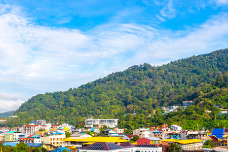 Panoramic view and panorama of tropical landscape mountains city skyline cityscape jungle forest and nature with blue sky in Patong Beach Kathu Phuket Island Province Thailand in Southeast Asia.の写真素材