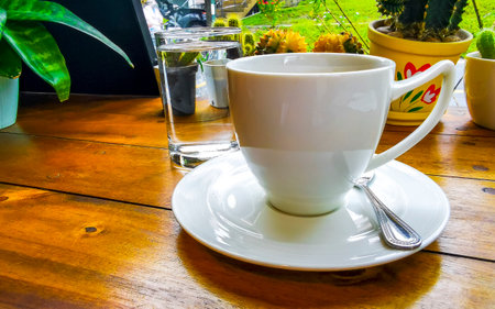 Glass cup of americano black coffee with spoon and plate on table food and drink in the restaurant cafe in Patong Beach Kathu District Phuket Island Province Southern Thailand in Southeast Asia.の写真素材