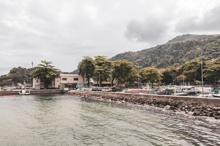 Panorama of tropical coast beach seascape with turquoise green blue water pier port harbor with ships yachts and boats.の写真素材