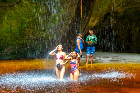 Presidente Figueiredo State of Amazonas Brazil December 20, 2020 Cave rainforest with waterfall limestone rocks trail people and interior of Gruta Palacio do Galo da Serra Gruta da Onca.のeditorial素材