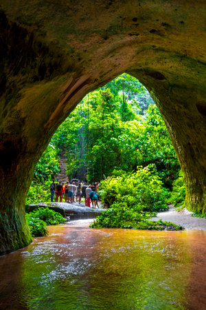 Presidente Figueiredo State of Amazonas Brazil December 20, 2020 Cave rainforest with waterfall limestone rocks trail people and interior of Gruta Palacio do Galo da Serra Gruta da Onca.のeditorial素材