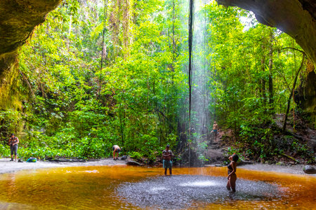 Presidente Figueiredo State of Amazonas Brazil December 20, 2020 Cave rainforest with waterfall limestone rocks trail people and interior of Gruta Palacio do Galo da Serra Gruta da Onca.のeditorial素材