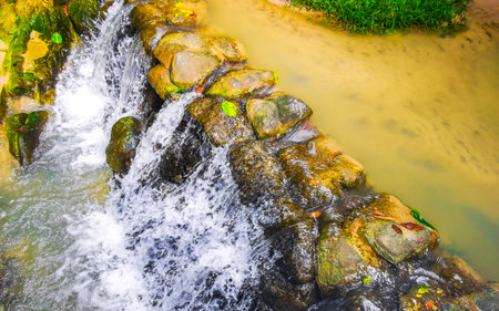 Wang Kee Oan Waterfall fall cascade flowing river water stream rocks and tropical jungle nature forest in Patong Beach Kathu District Phuket Island Province Southern Thailand in Southeast Asia.の写真素材