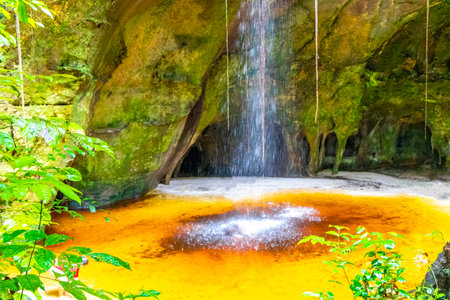 Presidente Figueiredo State of Amazonas Brazil December 20, 2020 Cave rainforest with waterfall limestone rocks trail people and interior of Gruta Palacio do Galo da Serra Gruta da Onca.の写真素材
