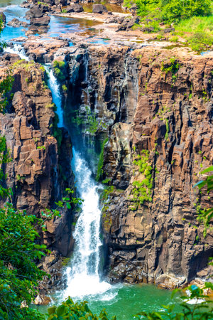 Foz do Iguacu Iguazu Falls waterfall fall waterfalls cascade cascades in tropical nature rainforest panorama view with blue sky and turquoise green water in Parana Brazil and Misiones Argentina.の写真素材