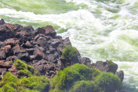 Foz do Iguacu Iguazu Falls waterfall fall waterfalls cascade cascades in tropical nature rainforest panorama view with blue sky and turquoise green water in Parana Brazil and Misiones Argentina.の写真素材