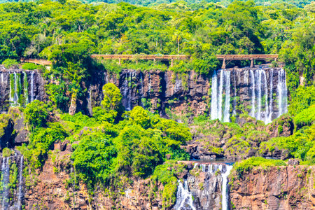 Foz do Iguacu Iguazu Falls waterfall fall waterfalls cascade cascades in tropical nature rainforest panorama view with blue sky and turquoise green water in Parana Brazil and Misiones Argentina.の写真素材