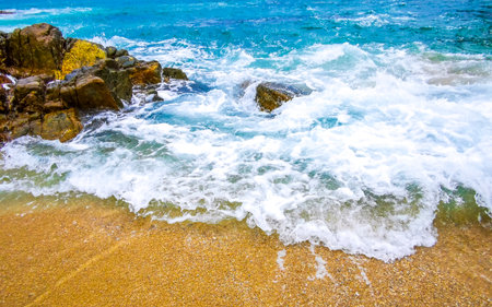 Rocky Kalim Beach tropical landscape panorama view with turquoise blue clear water waves and rocks in Patong Beach Kathu District Phuket Island Province Southern Thailand in Southeast Asia.の写真素材
