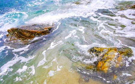 Rocky Kalim Beach tropical landscape panorama view with turquoise blue clear water waves and rocks...