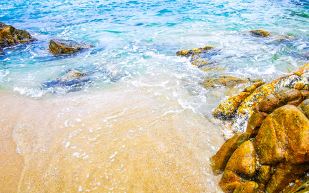 Rocky Kalim Beach tropical landscape panorama view with turquoise blue clear water waves and rocks...