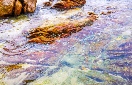Rocky Kalim Beach tropical landscape panorama view with turquoise blue clear water waves and rocks...