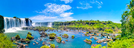Foz do Iguacu Parana Brazil December 26, 2020 Iguazu Falls waterfall fall waterfalls cascades in tropical nature panorama with wooden trail people blue sky turquoise green water Brazil and Argentina.のeditorial素材