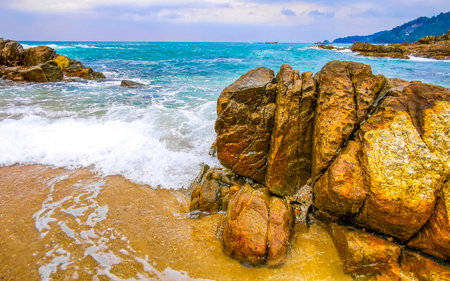 Amazing rocky tropical landscape panorama view with blue sky turquoise water waves and rocks in Phuket Province Southern Thailand in Southeast Asia.の写真素材