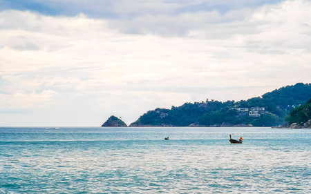 Amazing rocky Kalim Beach tropical landscape panorama view with blue sky turquoise water waves and rocks in Patong Beach Kathu District Phuket Island Province Southern Thailand in Southeast Asia.の写真素材