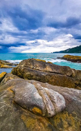 Amazing rocky tropical landscape panorama view with blue sky turquoise water waves and rocks.の写真素材