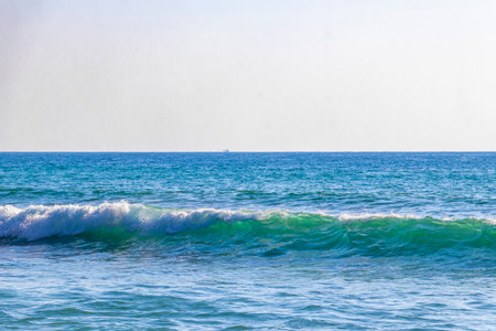 Rocky tropical landscape panorama view with turquoise blue clear water waves wave and splash.の写真素材