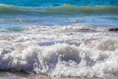 Rocky Kalim Beach tropical landscape panorama view with turquoise blue clear water waves and splash in Patong Beach Kathu District Phuket Island Province Southern Thailand in Southeast Asia.の写真素材