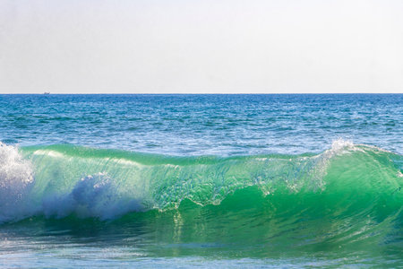Rocky Kalim Beach tropical landscape panorama view with turquoise blue clear water waves and splash in Patong Beach Kathu District Phuket Island Province Southern Thailand in Southeast Asia.の写真素材