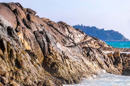 Rocky Kalim Beach tropical landscape panorama view with turquoise blue clear water waves sand and rocks in Patong Beach Kathu District Phuket Island Province Southern Thailand in Southeast Asia.の写真素材