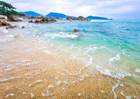 Amazing rocky tropical landscape panorama view with blue sky turquoise water waves and rocks in Phuket Island Province Southern Thailand in Southeast Asia.の写真素材
