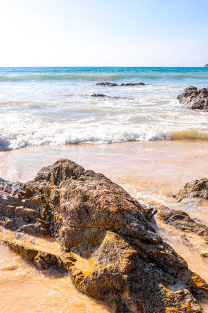 Rocky Kalim Beach tropical landscape panorama view with turquoise blue clear water waves sand and rocks in Patong Beach Kathu District Phuket Island Province Southern Thailand in Southeast Asia.の写真素材