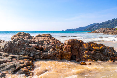 Rocky Kalim Beach tropical landscape panorama view with turquoise blue clear water waves sand and rocks in Patong Beach Kathu District Phuket Island Province Southern Thailand in Southeast Asia.の写真素材