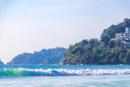 Rocky tropical landscape panorama view with turquoise blue clear water waves sand and rocks in Kathu District Phuket Island Province Southern Thailand in Southeast Asia.の写真素材