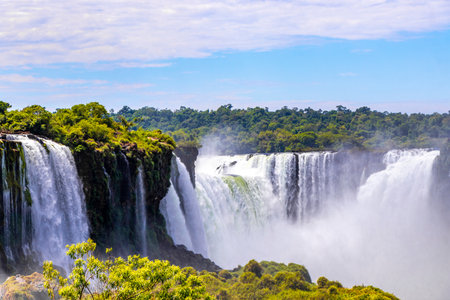 Foz do Iguacu Iguazu Falls waterfall fall waterfalls cascade cascades in tropical nature rainforest panorama view with blue sky and turquoise green water in Parana Brazil and Misiones Argentina.の写真素材