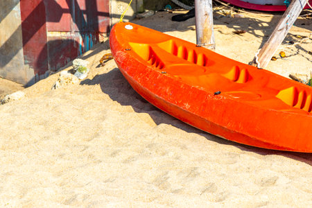 Canoe canoes kayak kayaks boat boats on the beach with sand and turquoise blue water.の写真素材