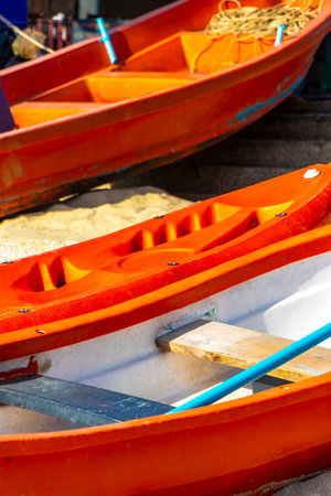 Canoe canoes kayak kayaks boat boats on the beach with sand and turquoise blue water in Patong Beach Kathu District Phuket Island Province Southern Thailand in Southeast Asia.の写真素材