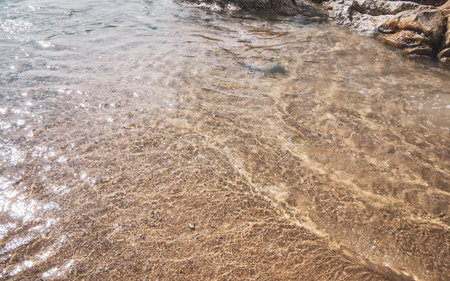 Kalim Beach rocky landscape seascape with turquoise blue clear water waves sand and rocks in Patong Beach Kathu District Phuket Island Province Southern Thailand in Southeast Asia.の写真素材
